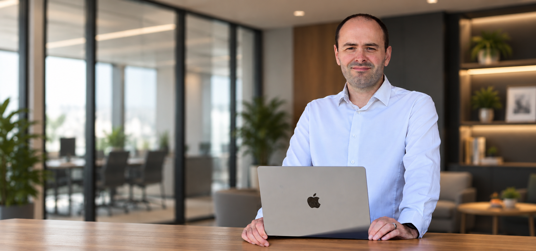 Russell Gilbert at a desk with his laptop