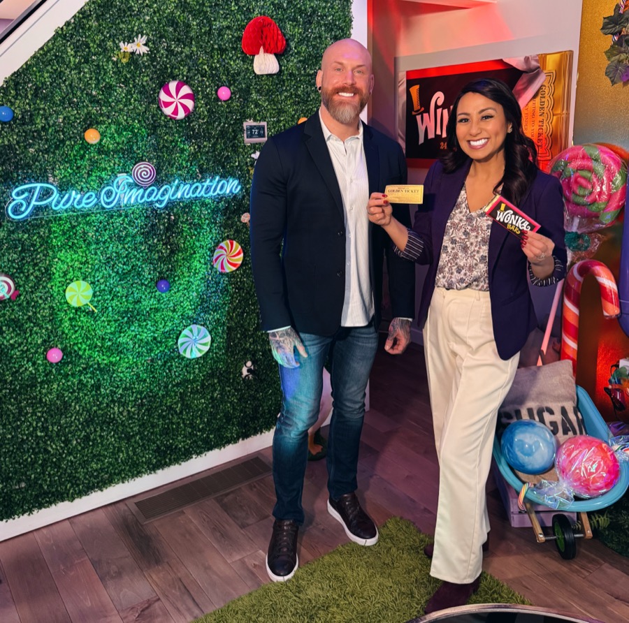 Brandon with a reporter at the themed rental
