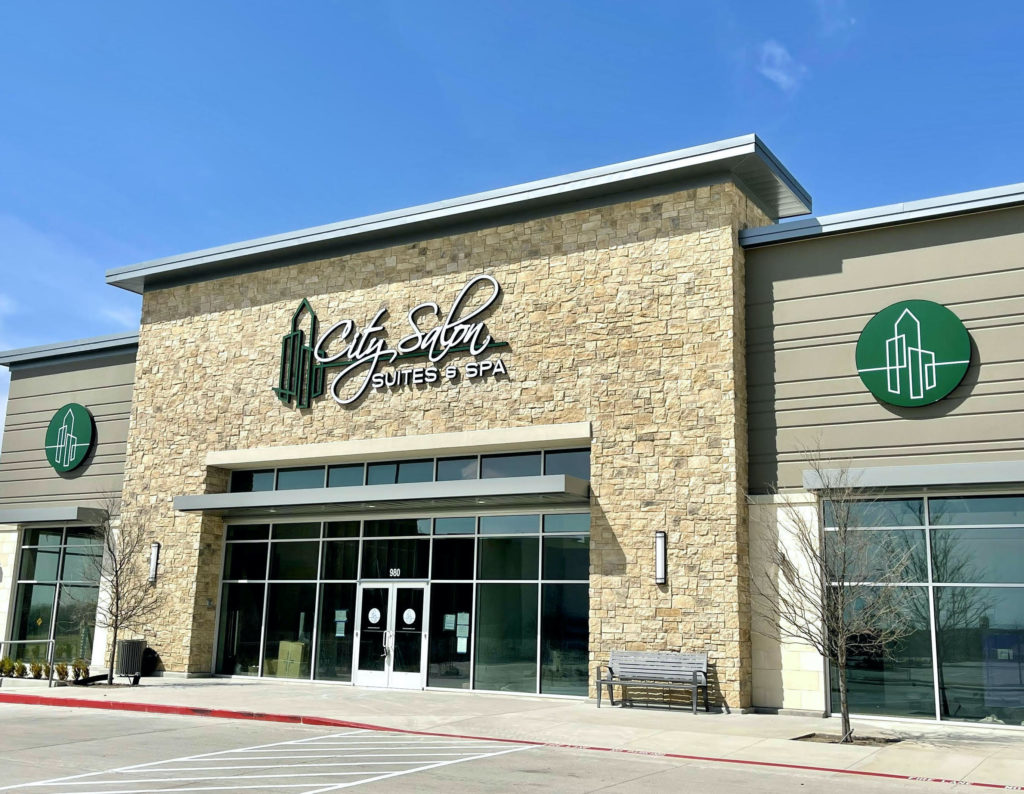 City Salon Suites & Spa exterior in Plano, Texas, featuring a stone facade, large windows, and a welcoming entrance, emphasizing advanced med spa services for skin rejuvenation and body contouring.