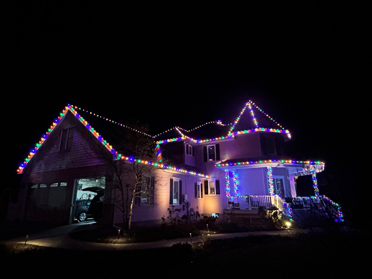 Completed Peak Lights multicolor roofline lighting on a Southern New Hampshire home