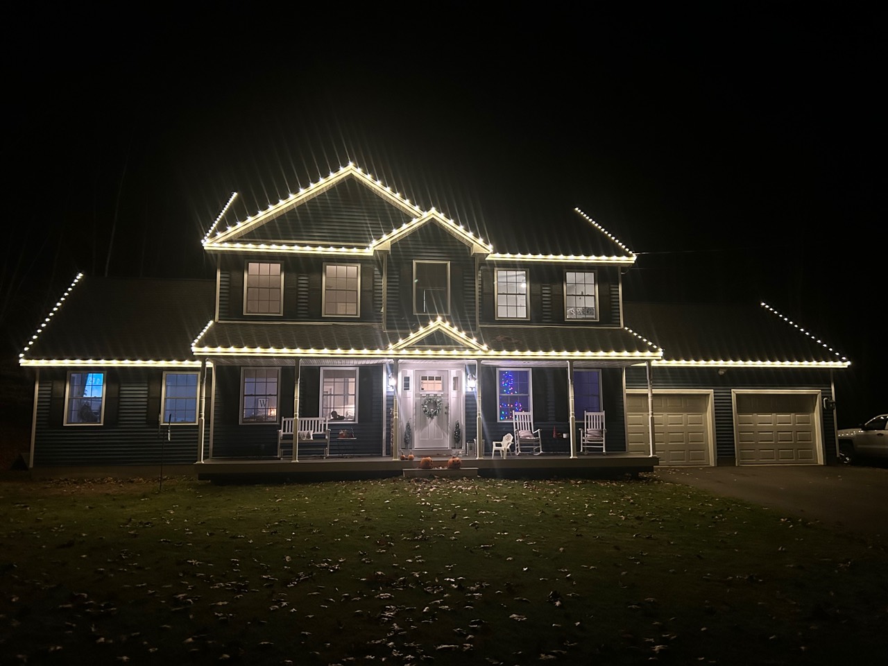 Completed Peak Lights warm-white roofline lighting on a Southern New Hampshire home