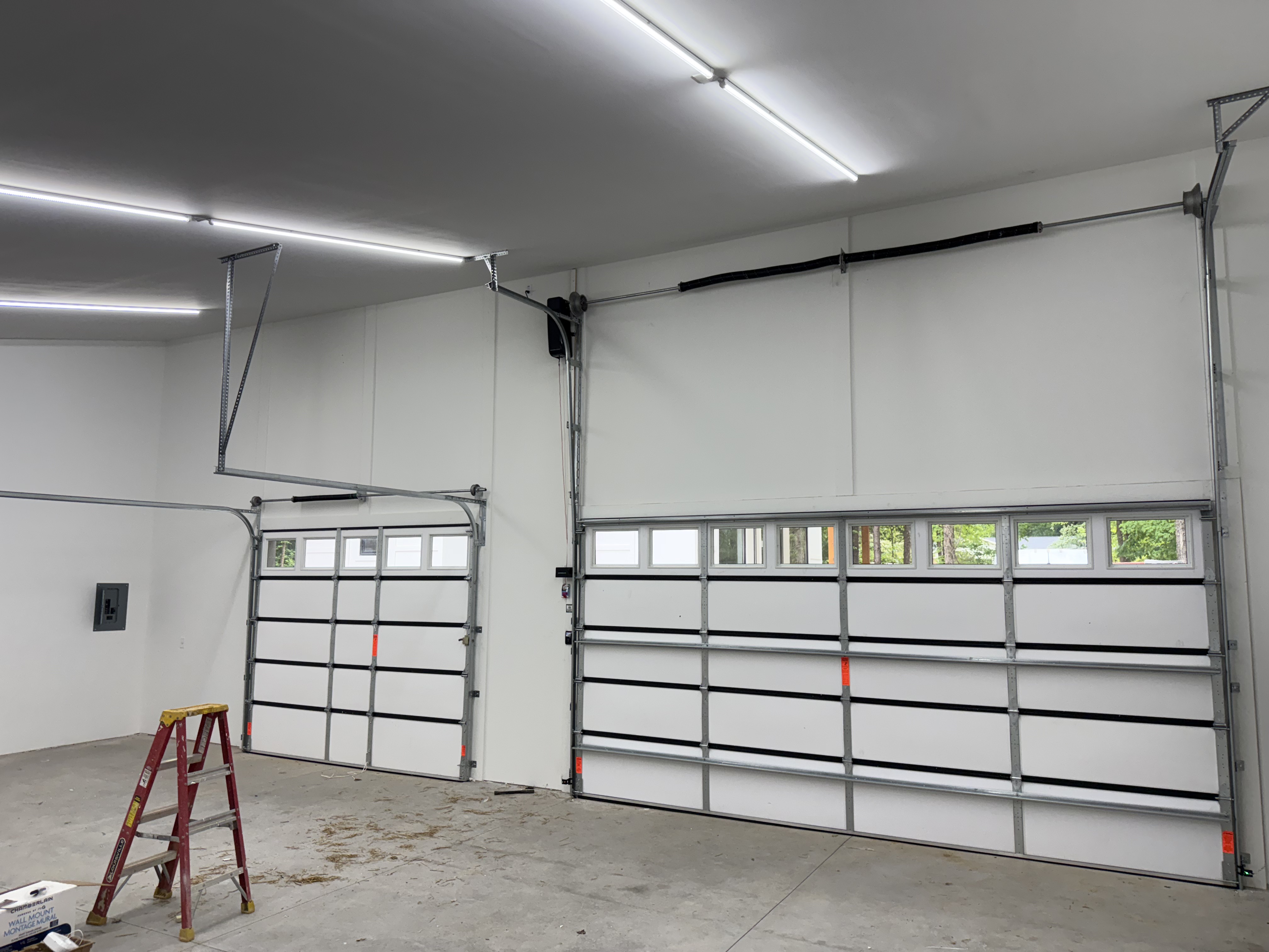 High-lift garage door track conversion with extended vertical tracks and high-lift drums installed by Garage Door Gators in Mint Hill NC
