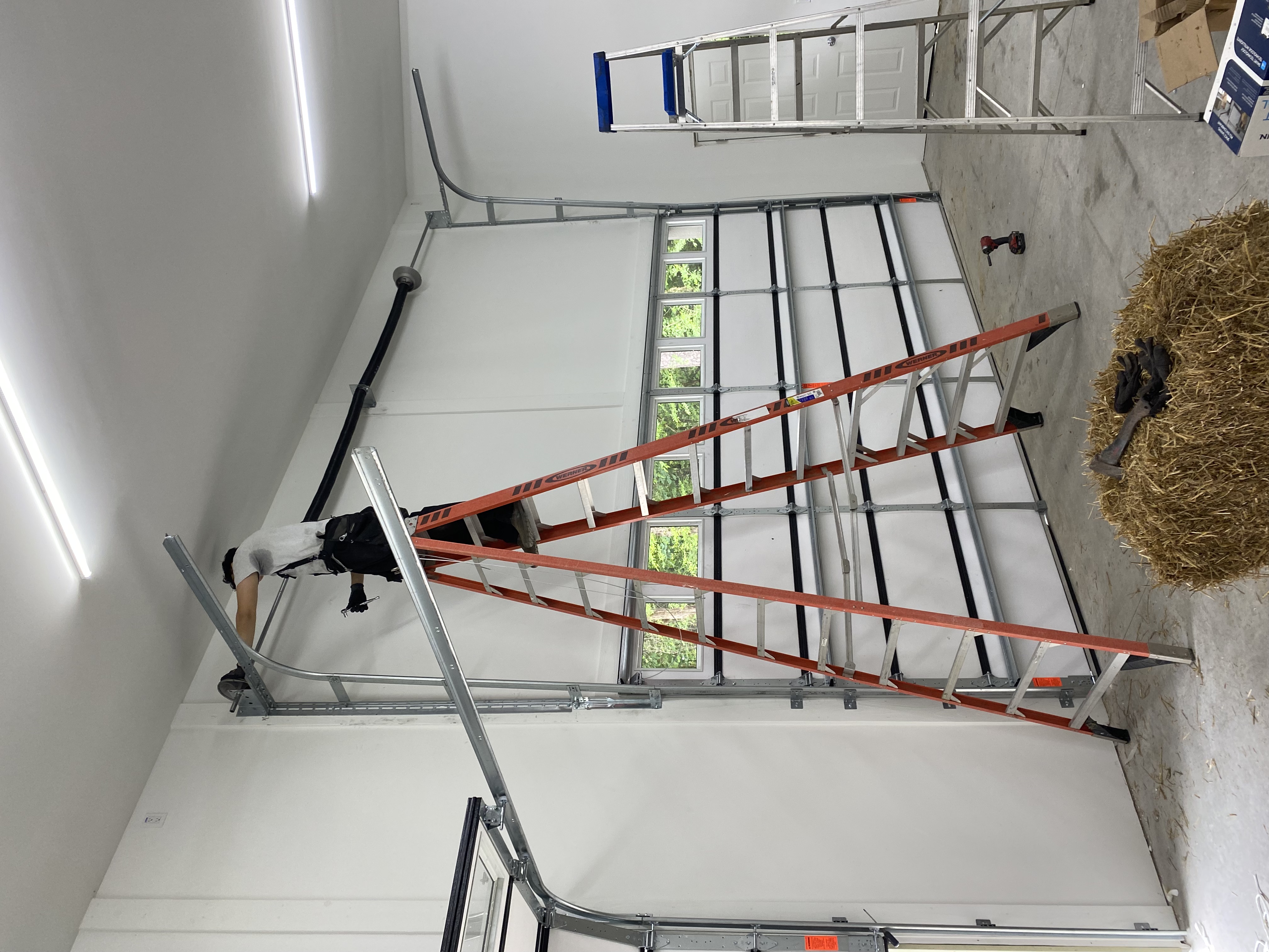 High-lift garage door conversion installed by Garage Door Gators showing extended vertical tracks and increased overhead clearance in Mint Hill NC