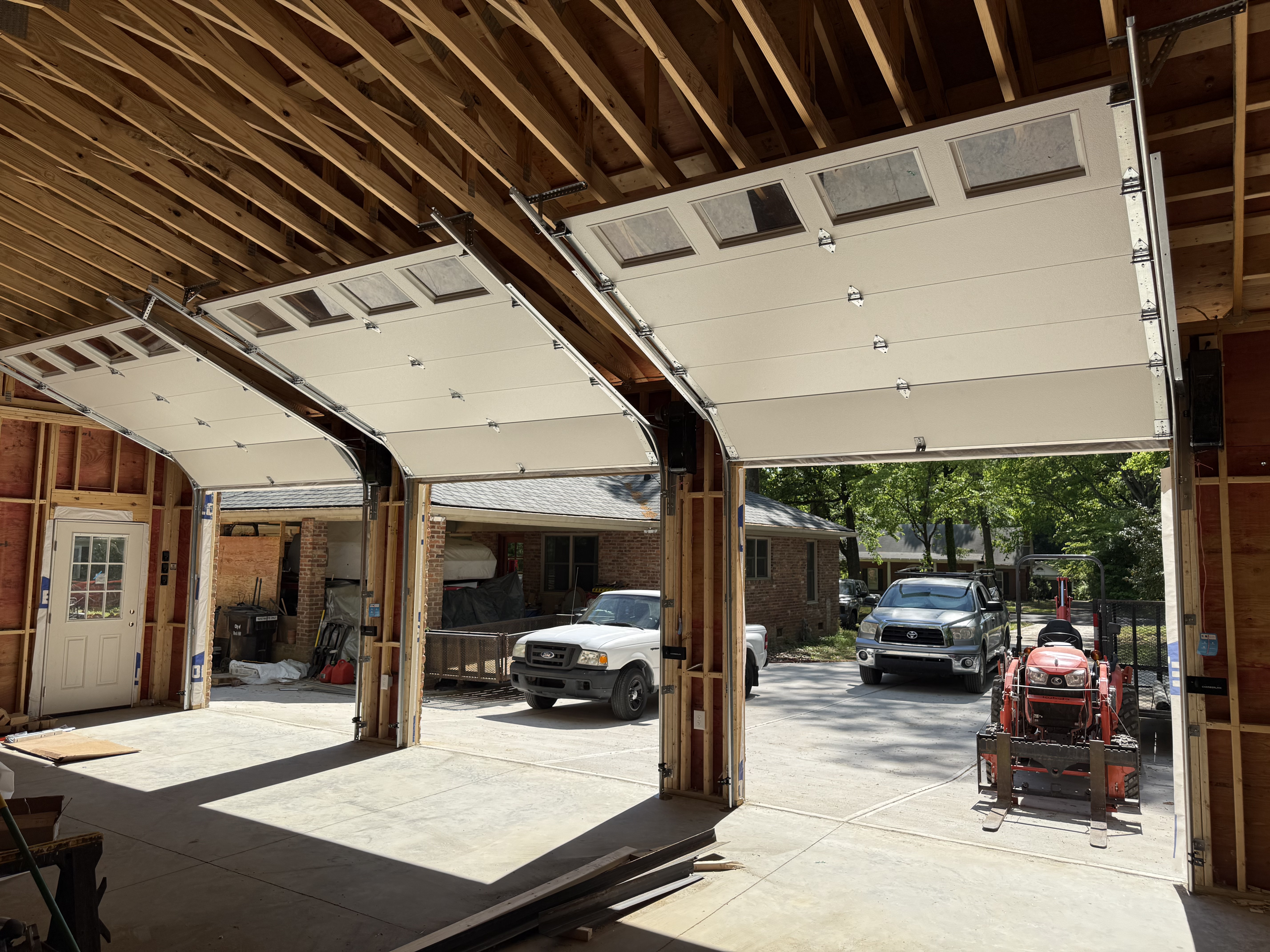 New garage door with factory high-lift hardware and custom torsion spring system installed by Garage Door Gators in the Charlotte NC area