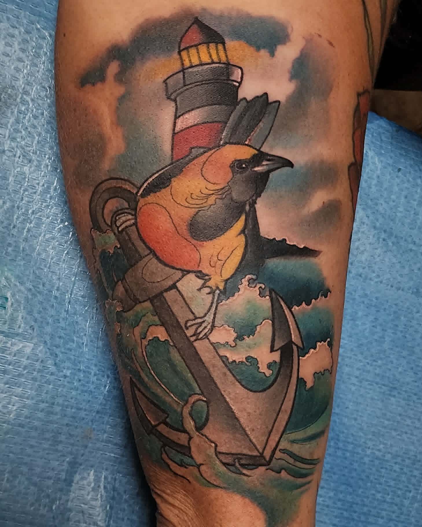Neo-traditional bird and anchor tattoo