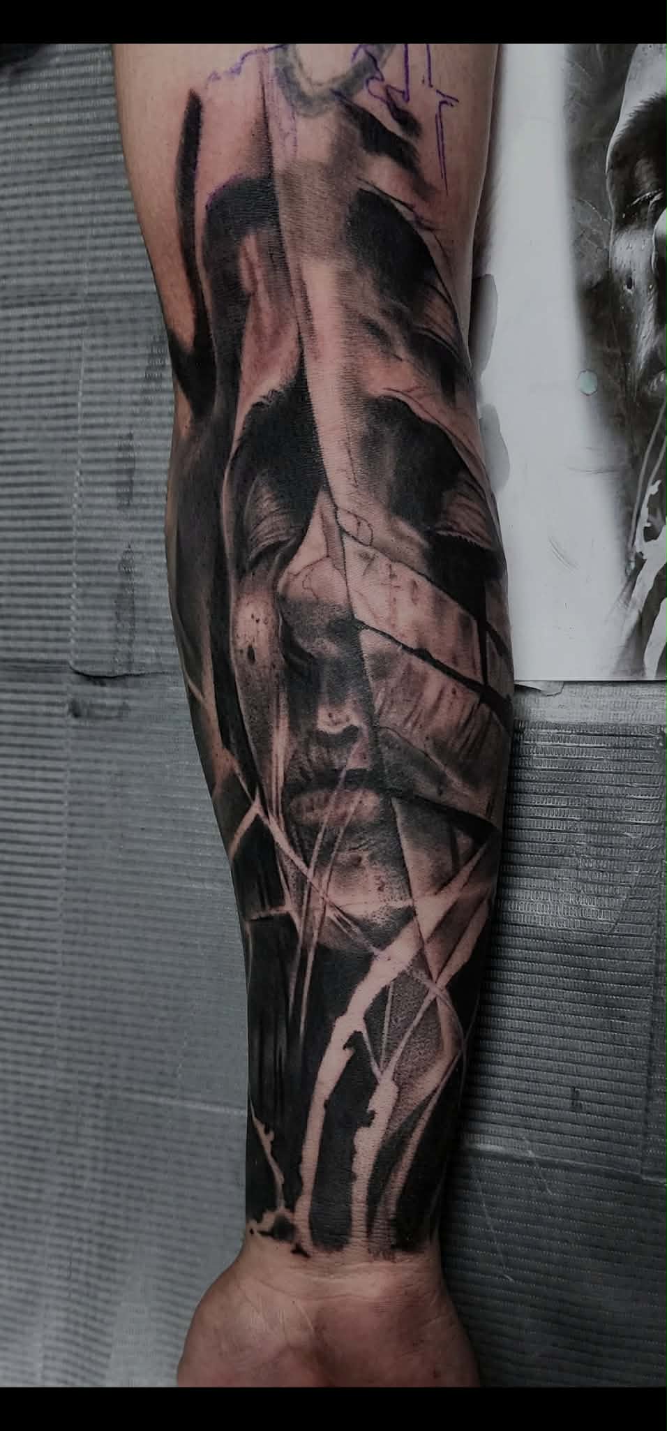 Abstract black and grey face tattoo