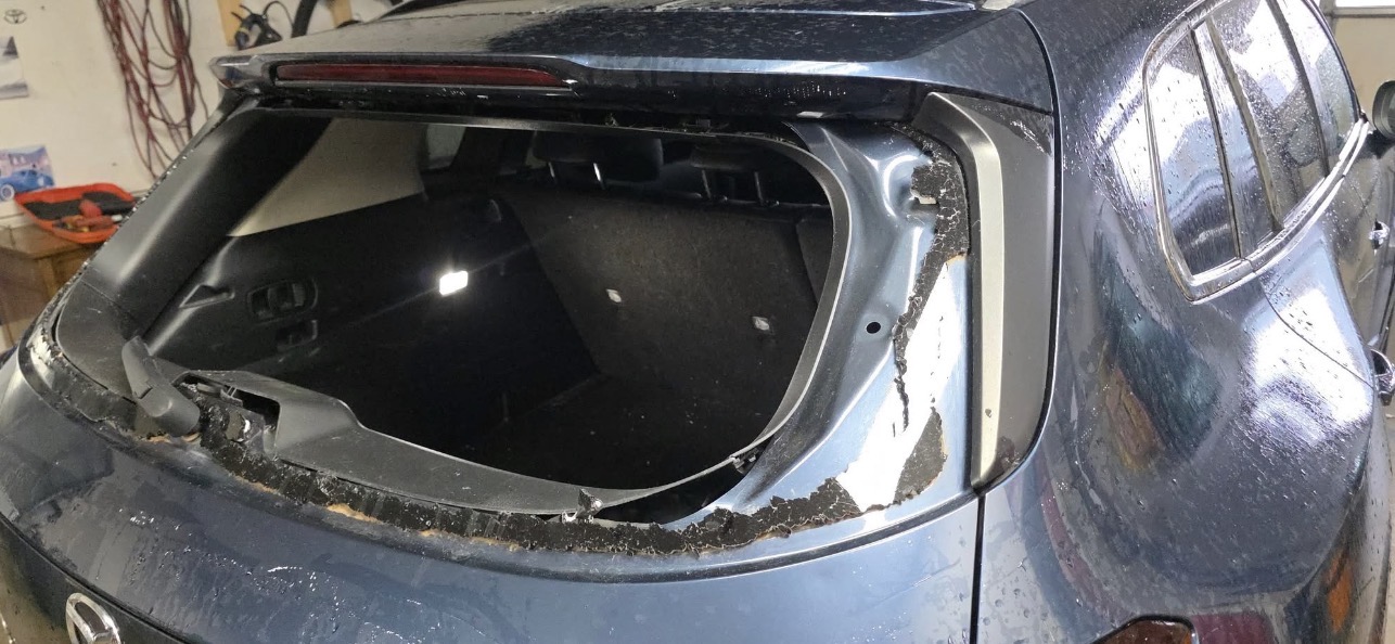 city auto glass rear window replacement dark suv empty frame indoor shop garage englewood co