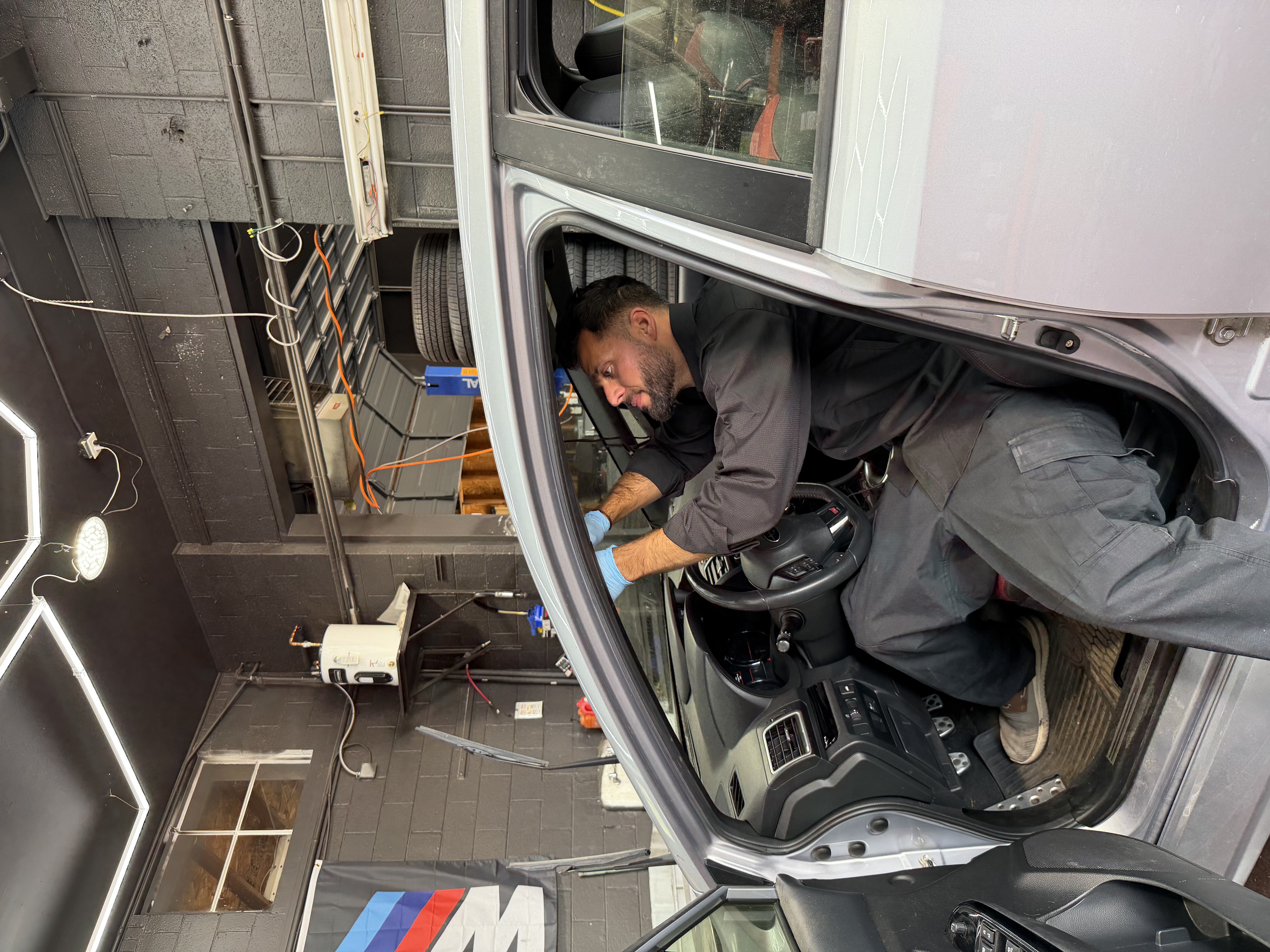 windshield replacement subaru wrx sti silver technician inside vehicle englewood co 09