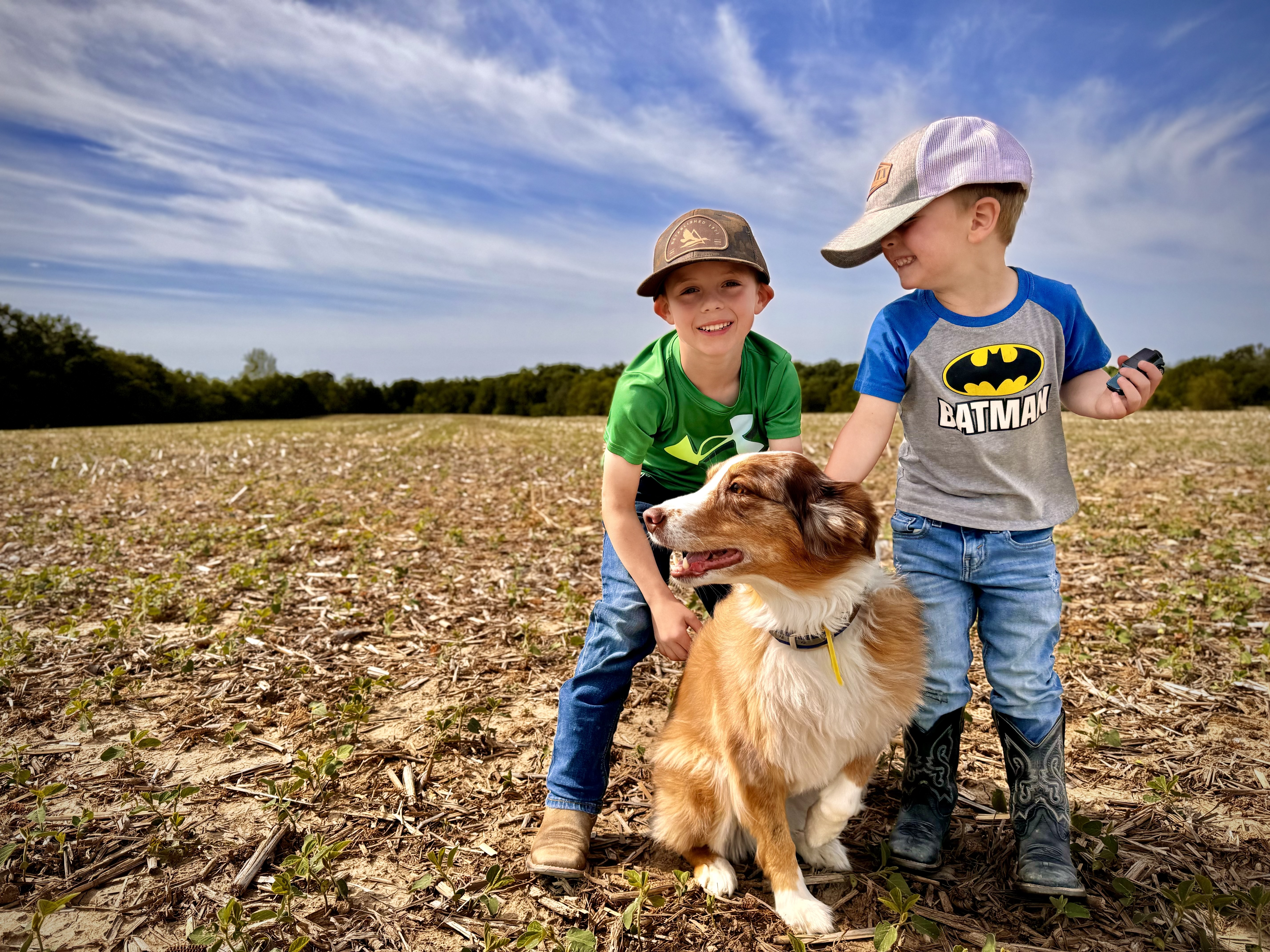 Two young boys with their dog on a central Illinois farm field — the next generation on the land — Archer Realty Two young boys with their dog on a central Illinois farm field — the next generation on the land — Archer Realty