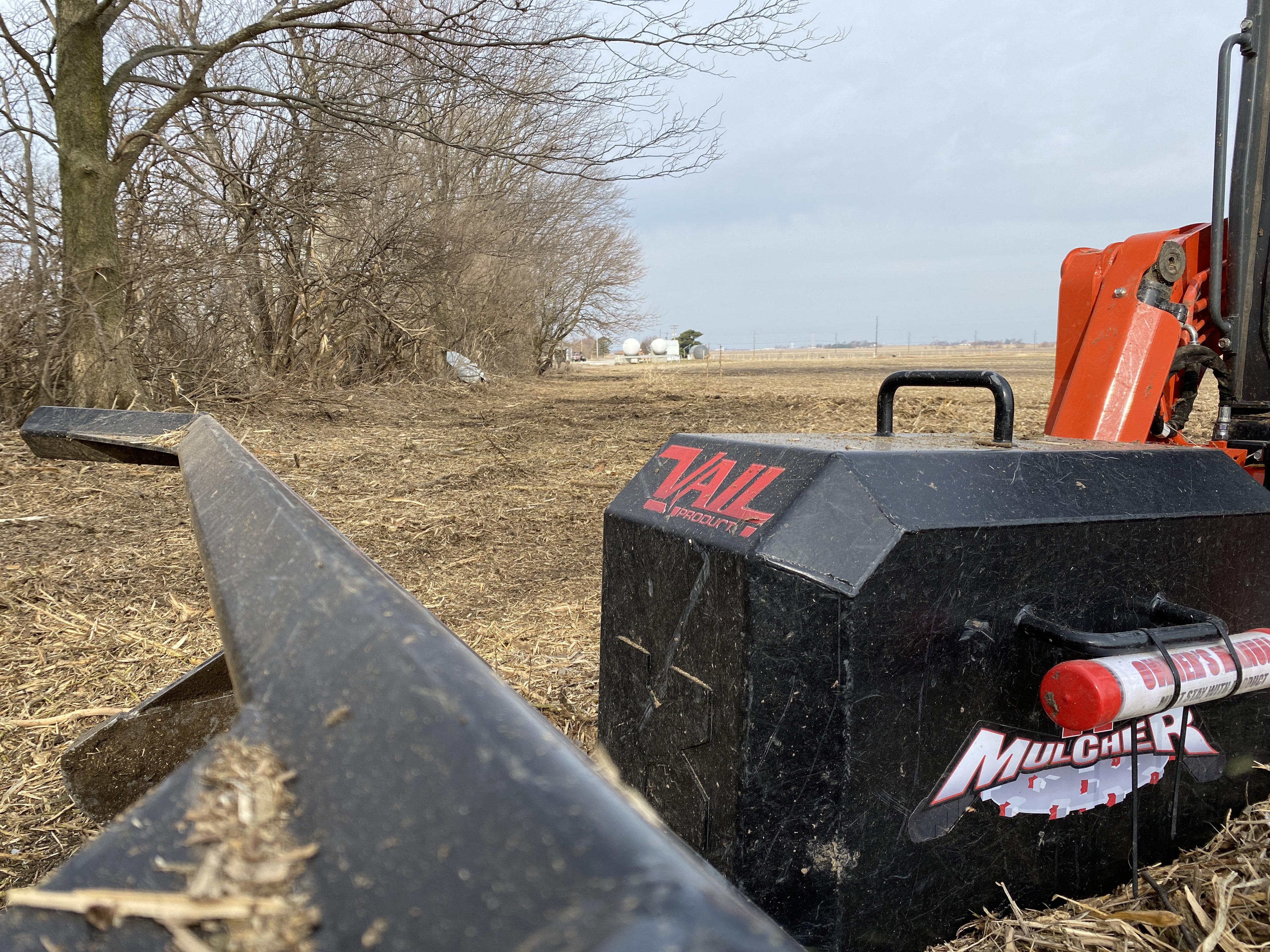 Forestry mulcher clearing field edge encroachment on Illinois farm — land management and ground reclamation — Archer Realty