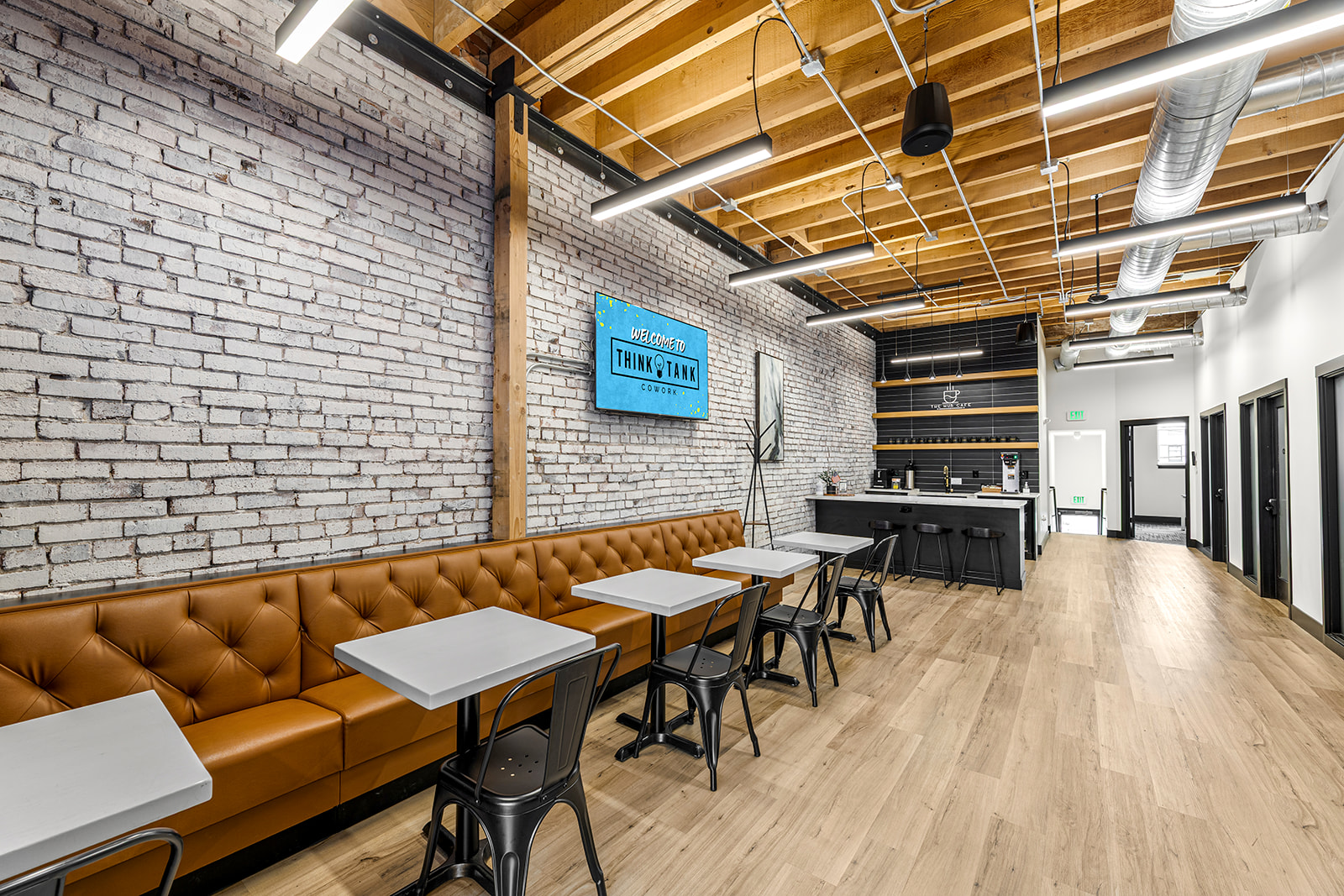The open workspace with tall windows and natural light at Think Tank Cowork in downtown Everett, Washington