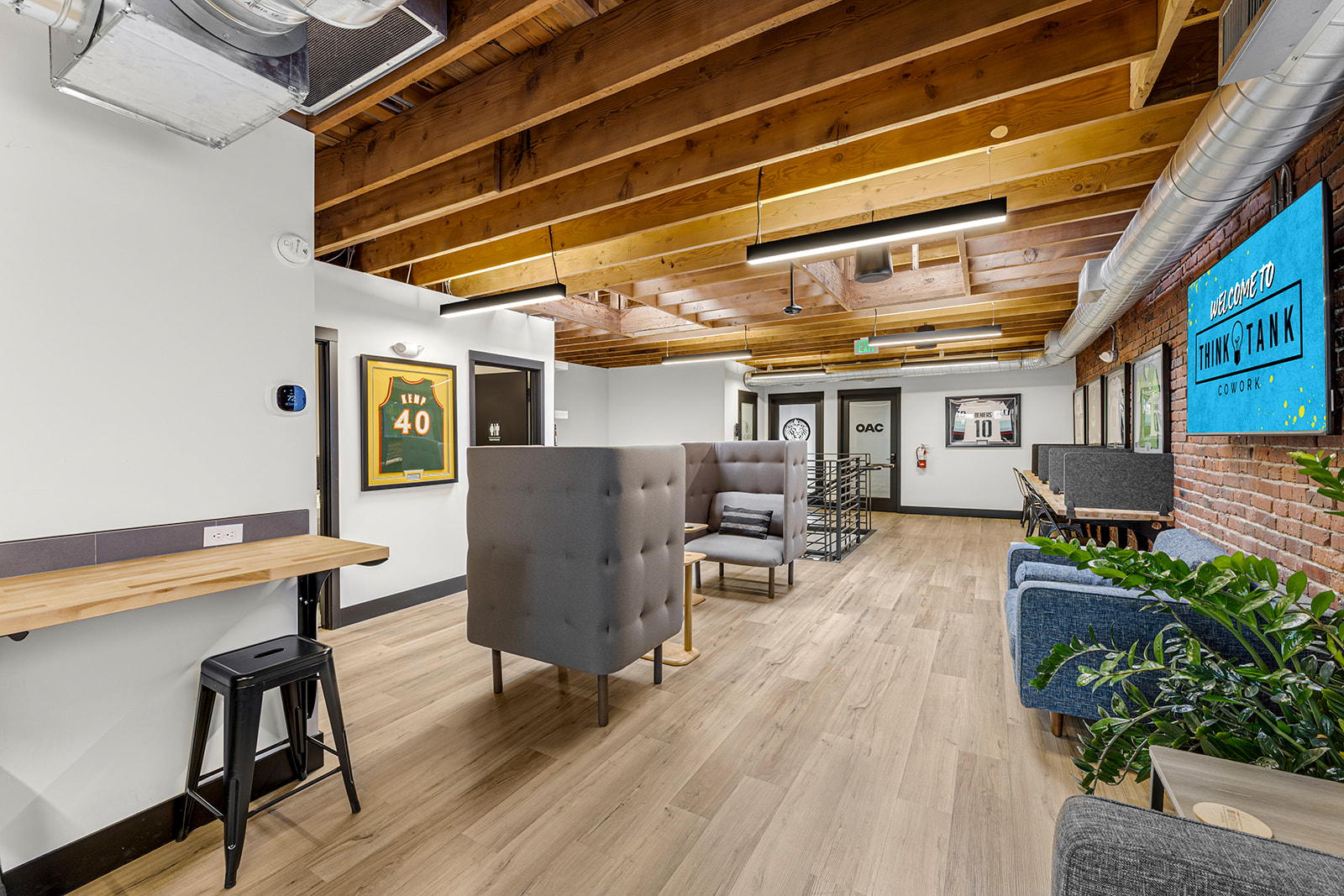 Members working at desks on the main coworking floor at Think Tank Cowork in downtown Everett, Washington