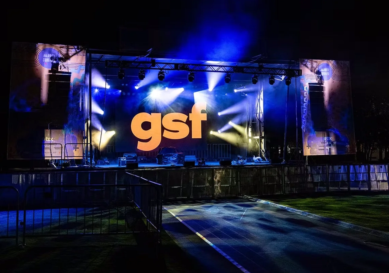 Concert stage with lighting beams and LED screens