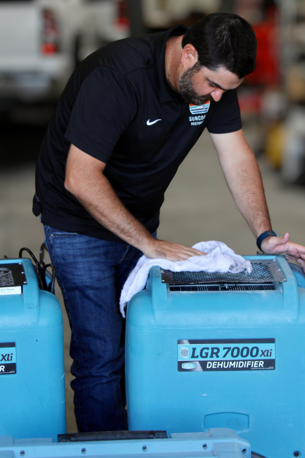 SunCoast Restoration technician working with professional drying equipment
