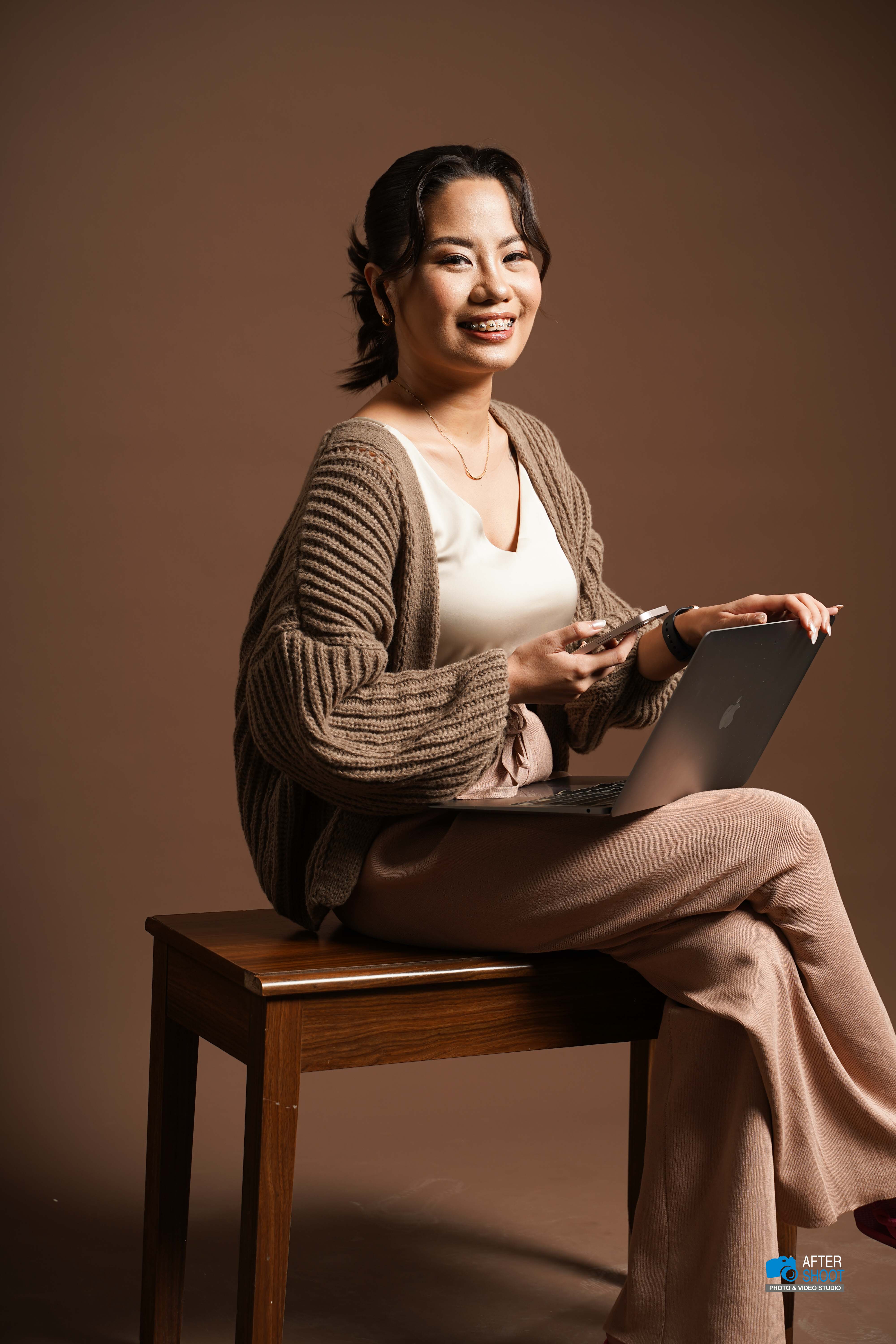 Shapei Tragico working from her laptop and phone