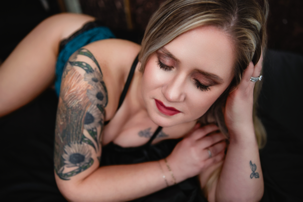 A woman in turquoise lingerie poses for a boudoir shoot in Indianapolis at Enchanted Moments Artistry A woman in turquoise lingerie poses for a boudoir shoot in Indianapolis at Enchanted Moments Artistry