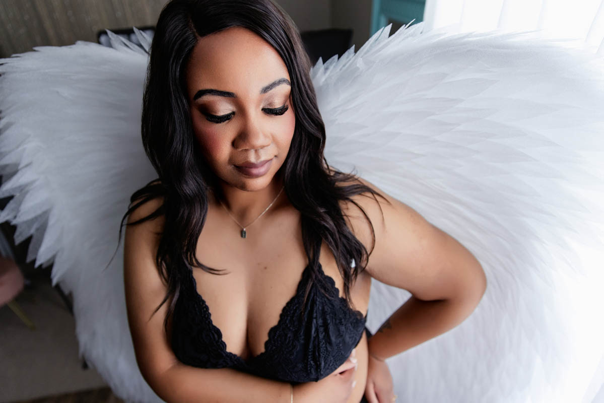 A woman in styled hair poses for a boudoir shoot in Indianapolis at Enchanted Moments Artistry. A woman in styled hair poses for a boudoir shoot in Indianapolis at Enchanted Moments Artistry.