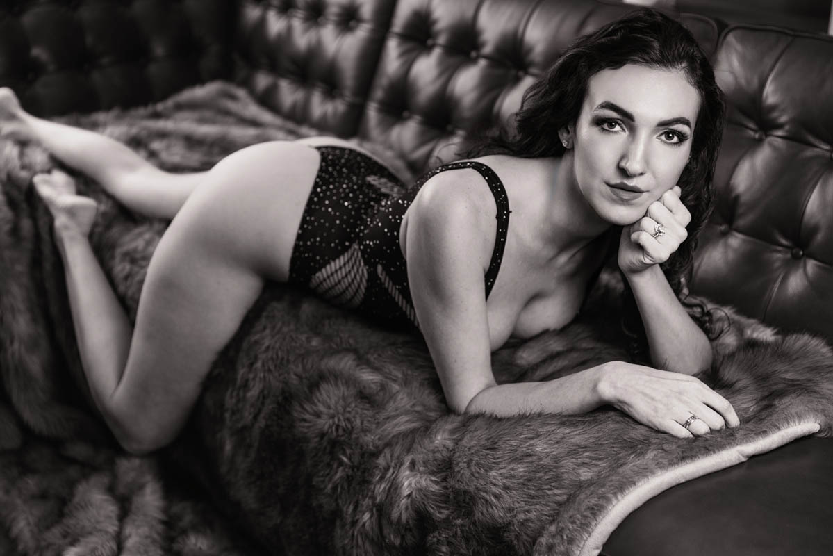 A black and white photo of a woman in lingerie posing for a boudoir shoot in Indianapolis at Enchanted Moments Artistry A black and white photo of a woman in lingerie posing for a boudoir shoot in Indianapolis at Enchanted Moments Artistry