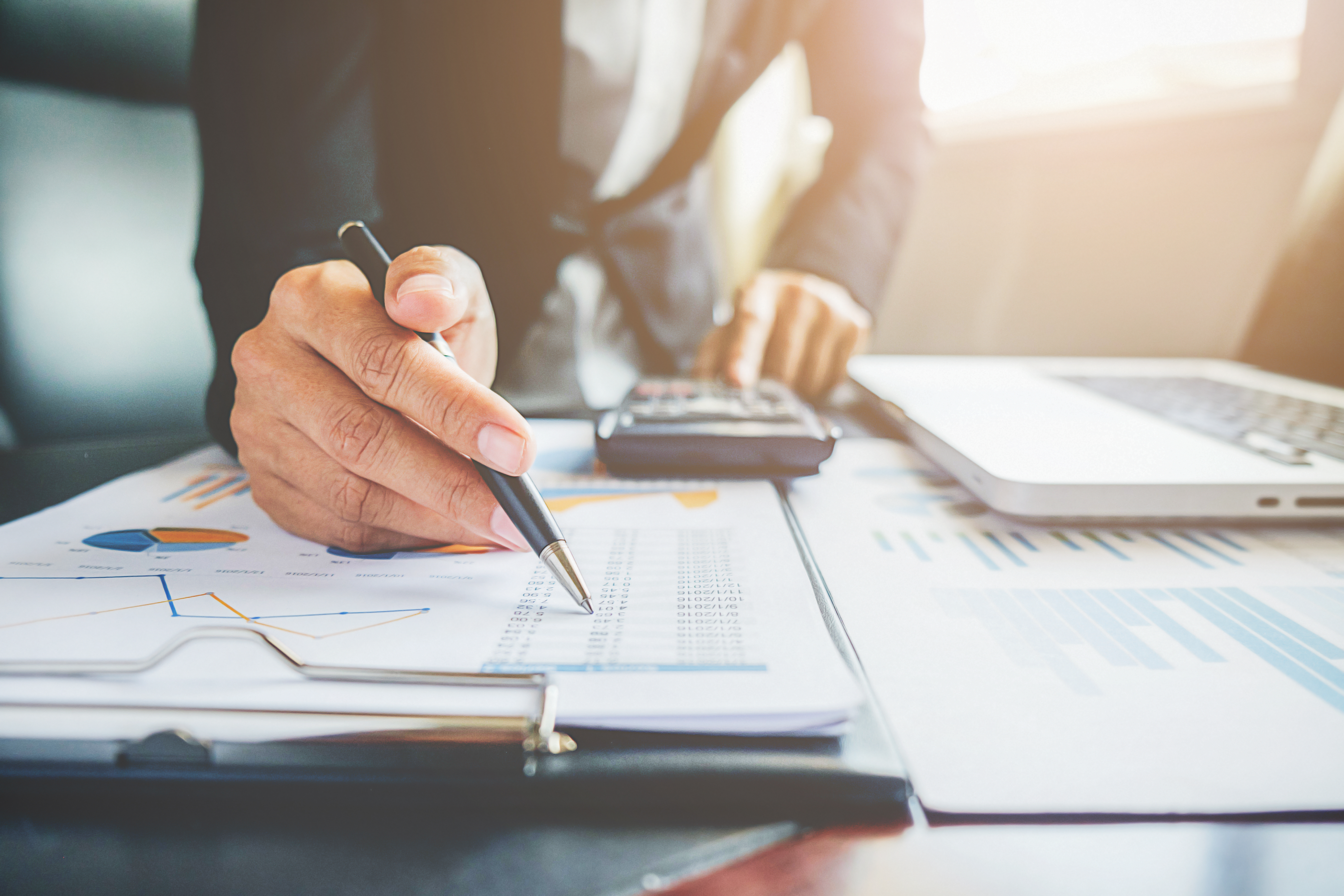 Bookkeeper reviewing detailed financial reports with clarity and precision