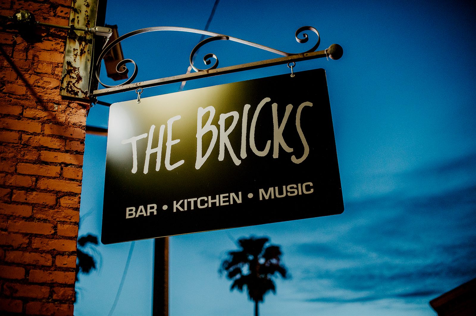 The Bricks hanging sign at dusk