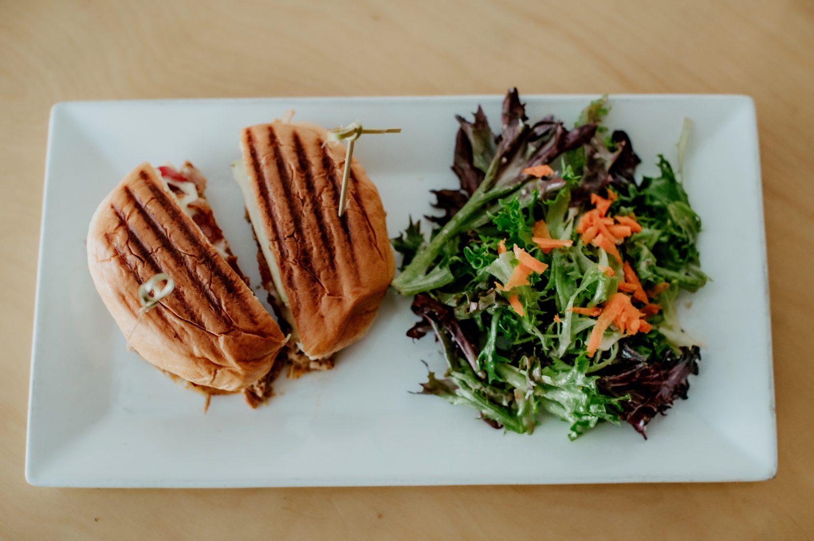 Pressed sandwich with a side salad at The Bricks