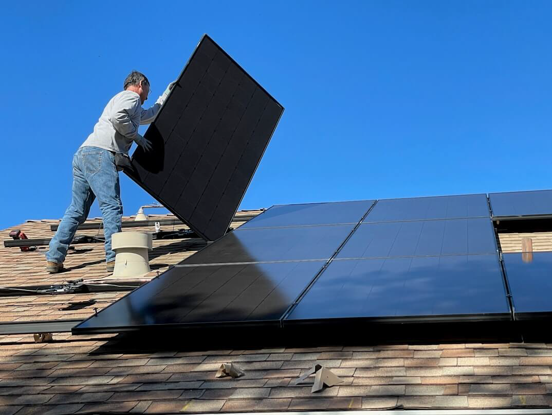 Technicians installing solar panels on a residential rooftop in Utah County, Utah, for sustainable energy and whole home backup power solutions