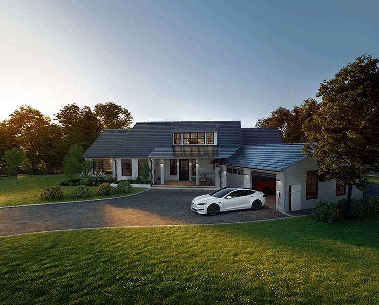Tesla Solar Roof home in Utah with Tesla Powerwall and Tesla vehicle in driveway at sunset