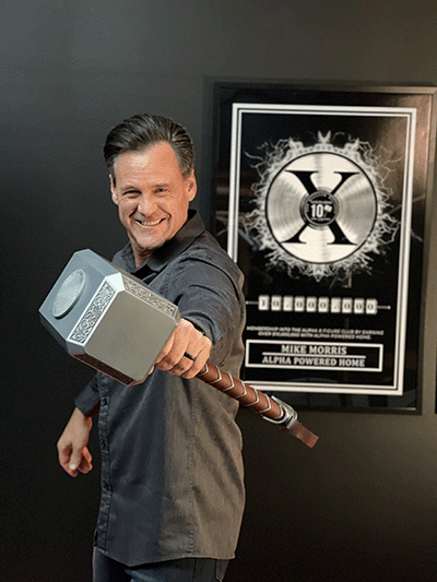 Mike Morris smiling and holding a hammer