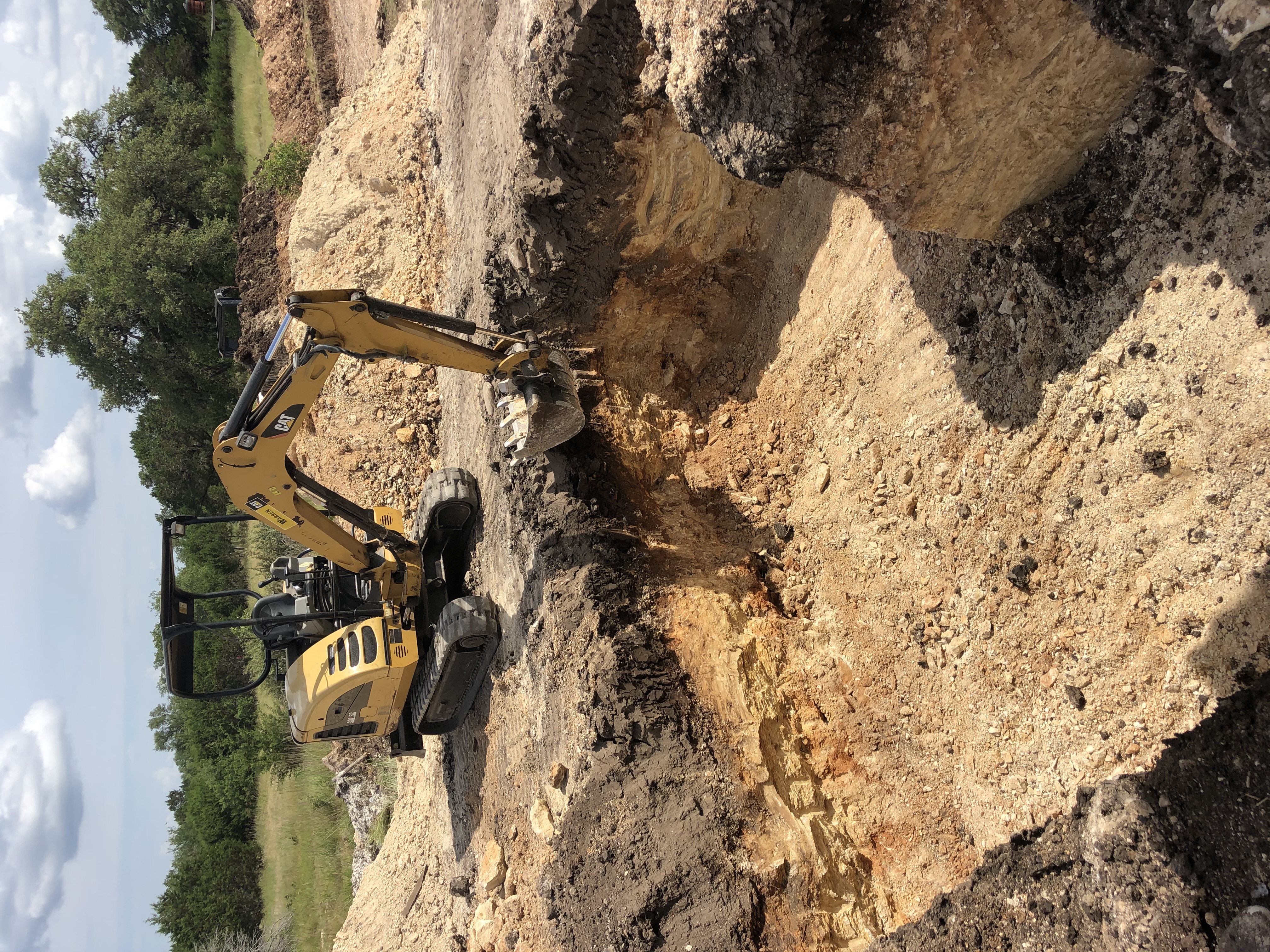 Motor grader smoothing a construction site