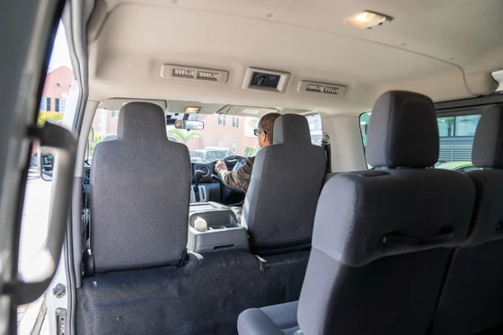 View from the rear seats toward the driver at the wheel
