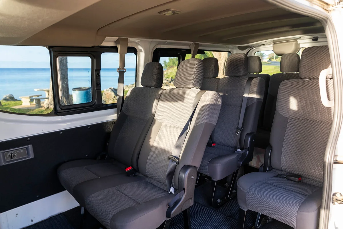 Inside the minibus, with the ocean visible through the side windows