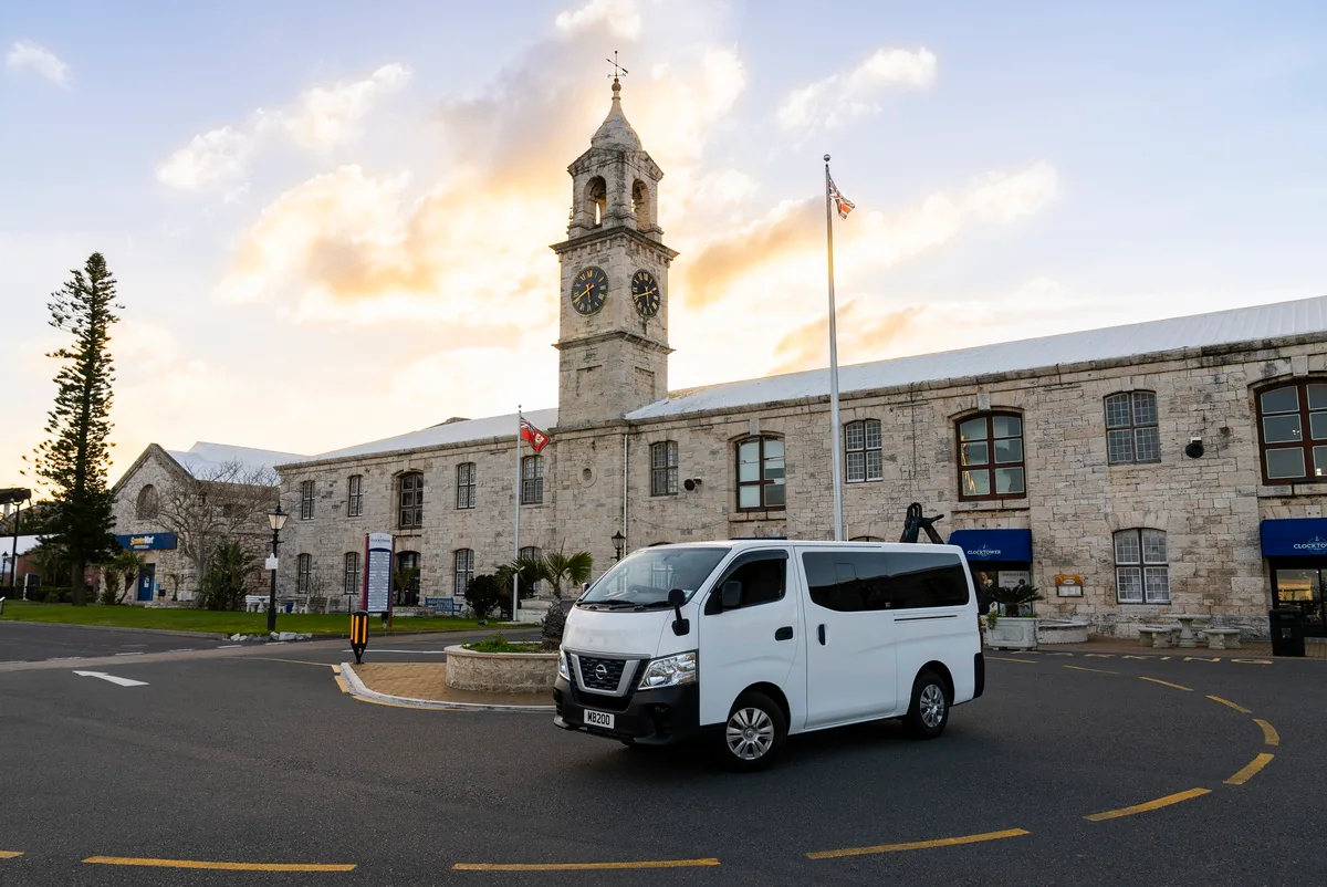 The INTO Bermuda minibus in front of the clock tower at Dockyard