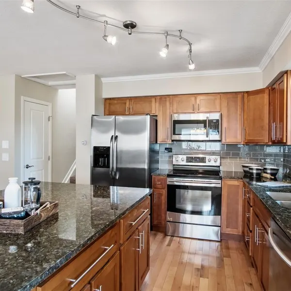 Same kitchen after renovation — granite and stainless steel