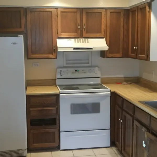 Kitchen before — original dated cabinets and appliances