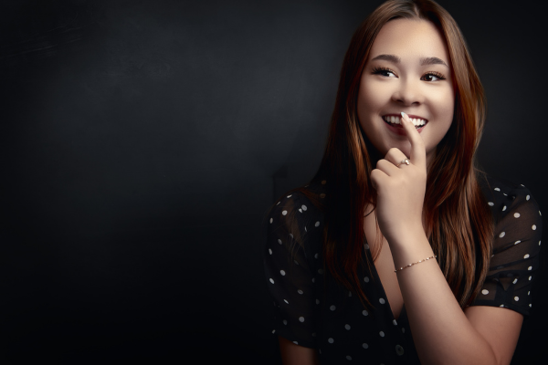 Editorial graduation portrait of a young woman photographed in studio lighting in Surrey BC