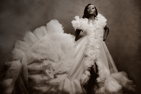 Editorial portrait of a woman in dramatic couture photographed in studio lighting in Surrey BC