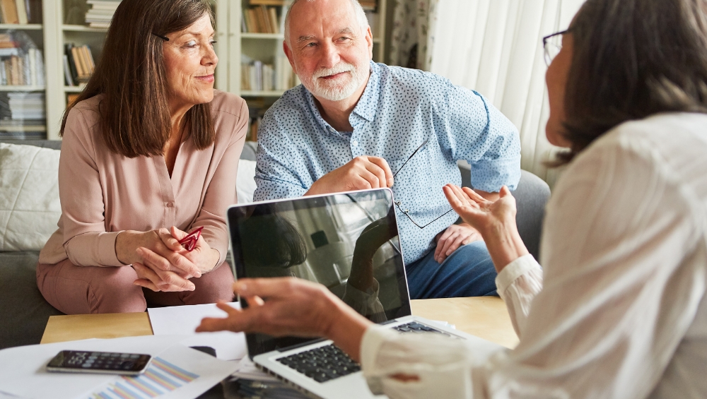 Friendly Medicare advisor helping Florida senior couple review 2026 plan options