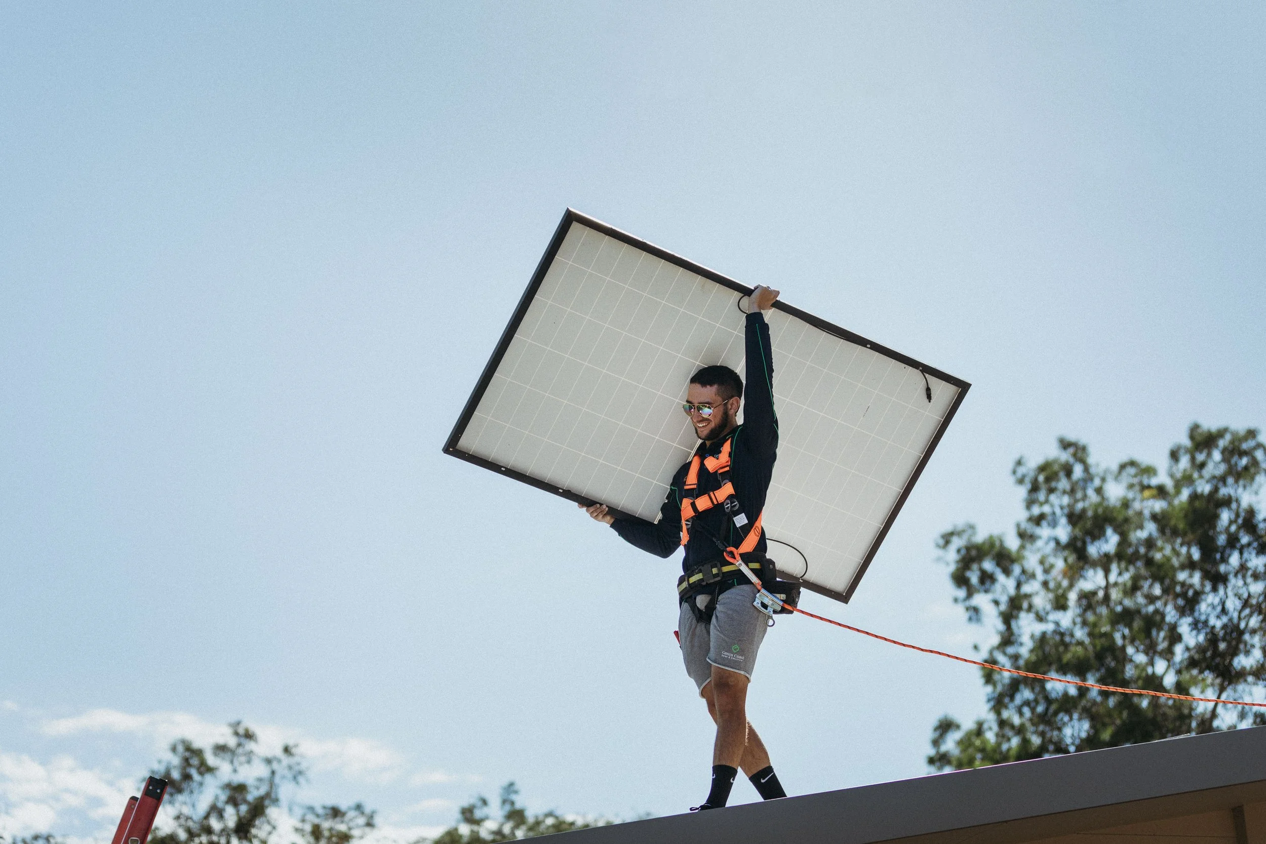 Installer lifting a Tier-1 solar panel