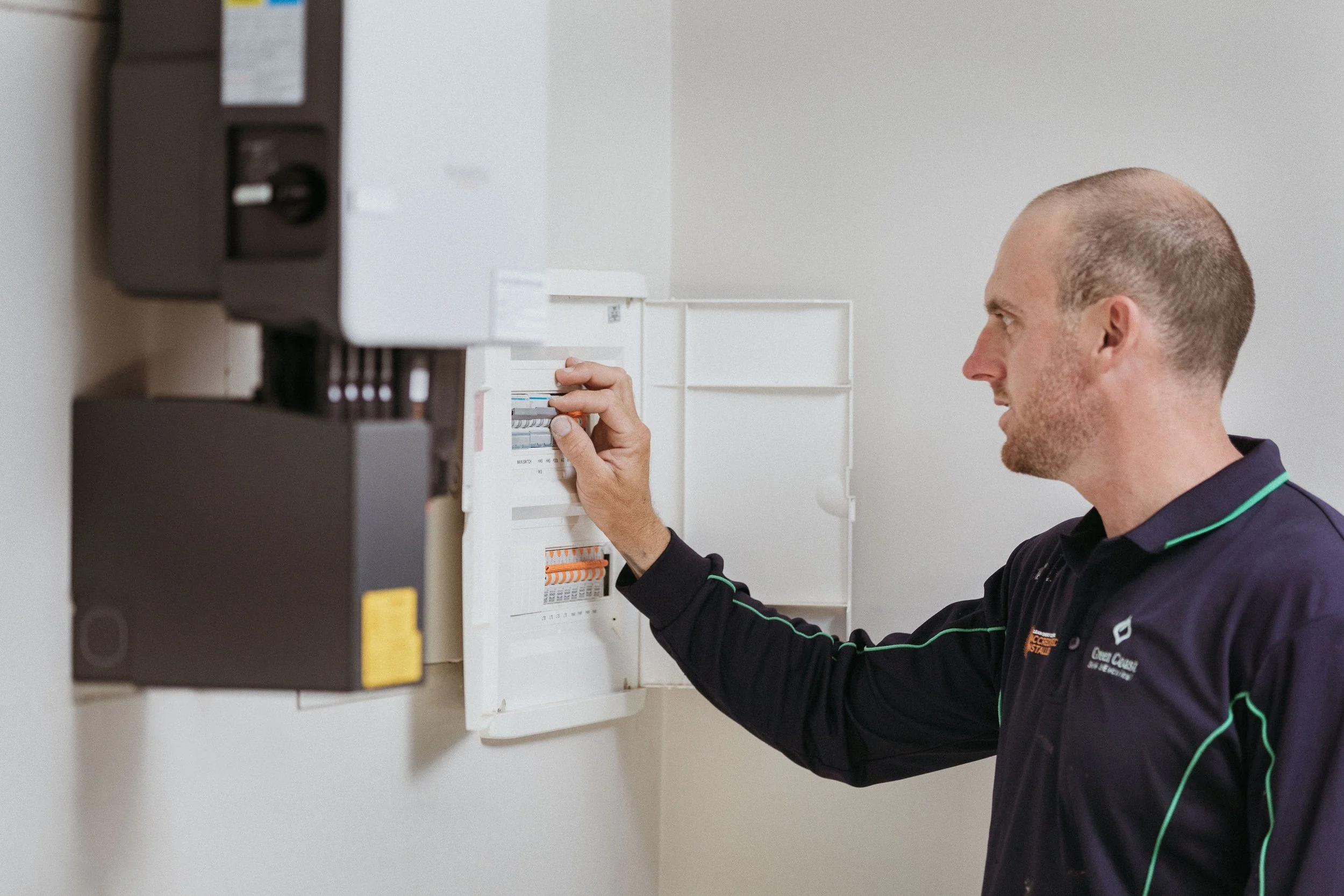 Licensed electrician installing a solar inverter