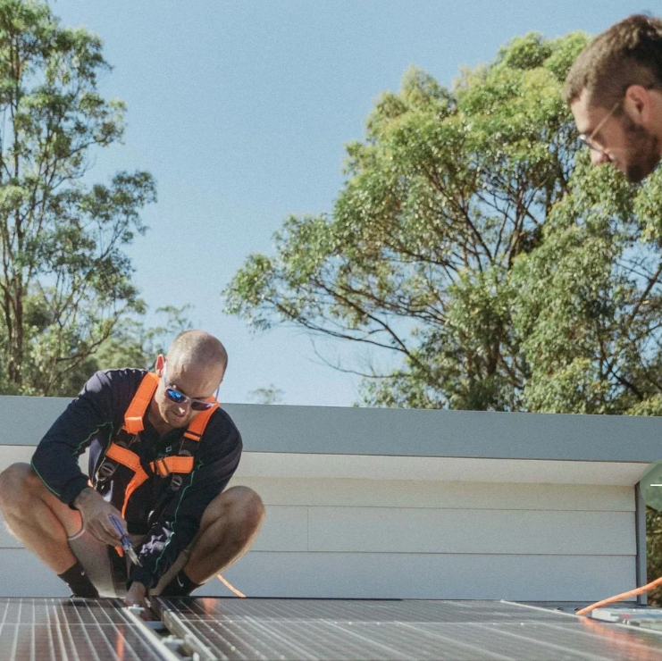 Ashley Hoedemaeckers installing solar panels on a Gold Coast rooftop