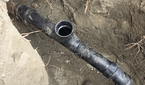 Sewer line repair service replacing damaged drain pipe in Coachella Valley