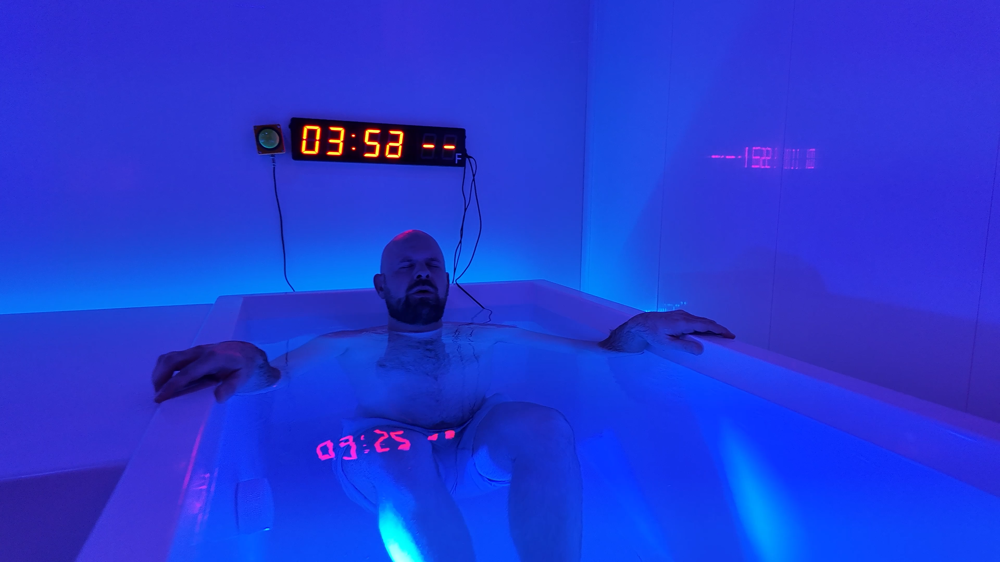Close-up of man in cold plunge with timer at Evolve Round Rock