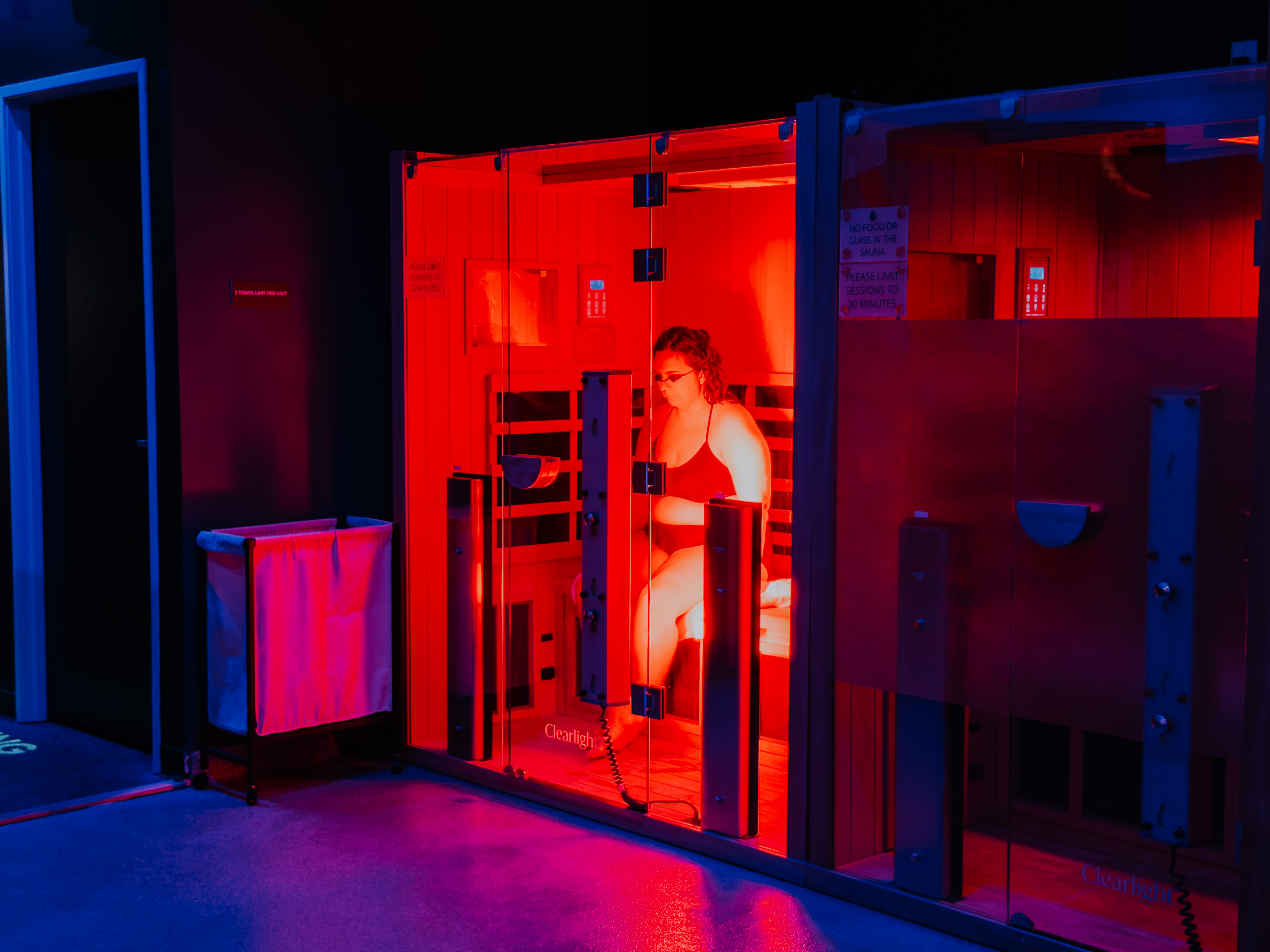 Cold plunge room with two people and blue LED timers at Evolve