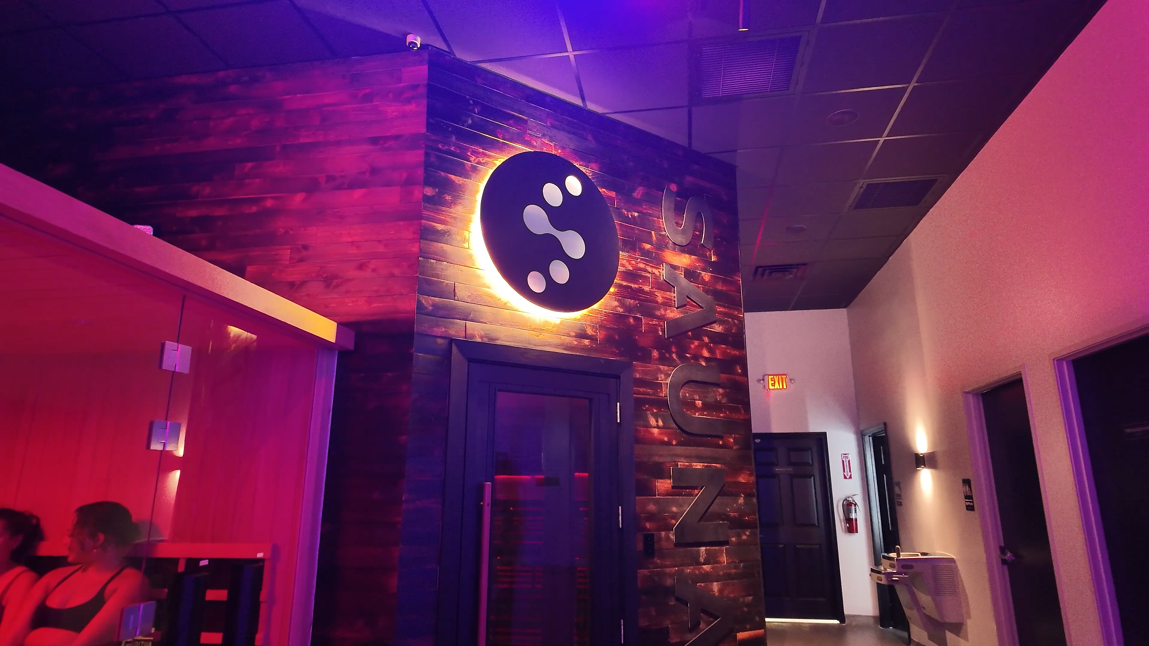 Evolve Social Wellness Space lobby hallway with illuminated logo