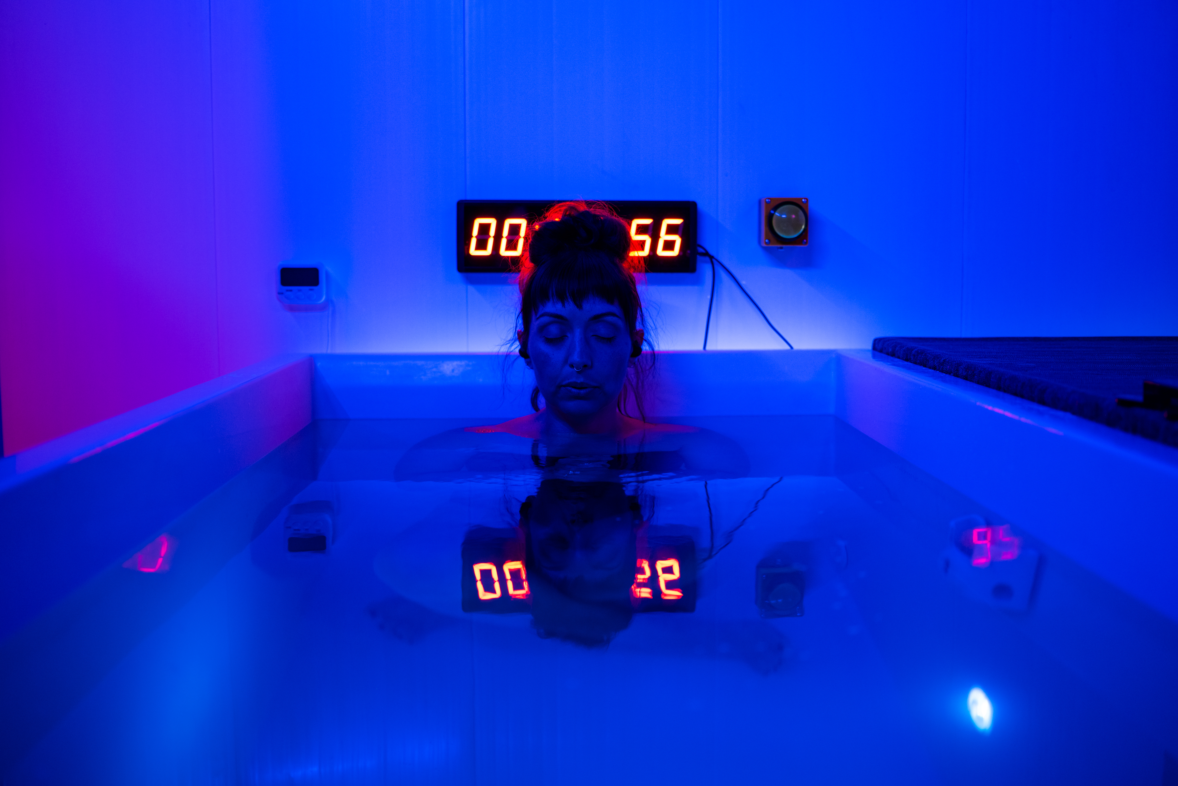 Man meditating cross-legged in infrared sauna
