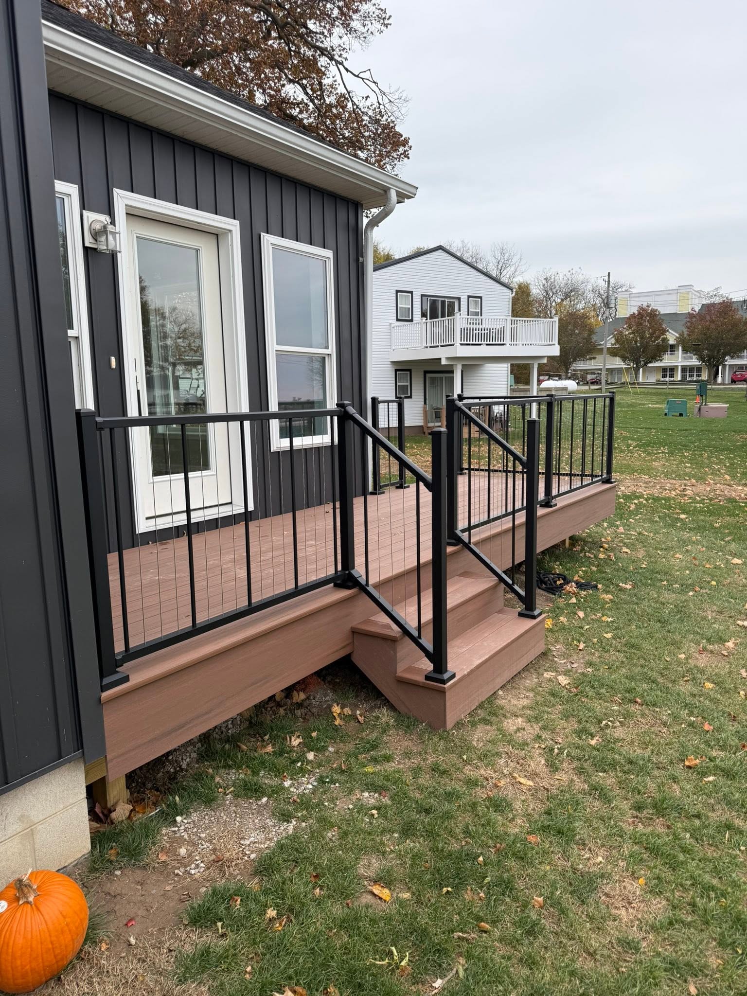 Composite deck with black railing built by Snoble Construction