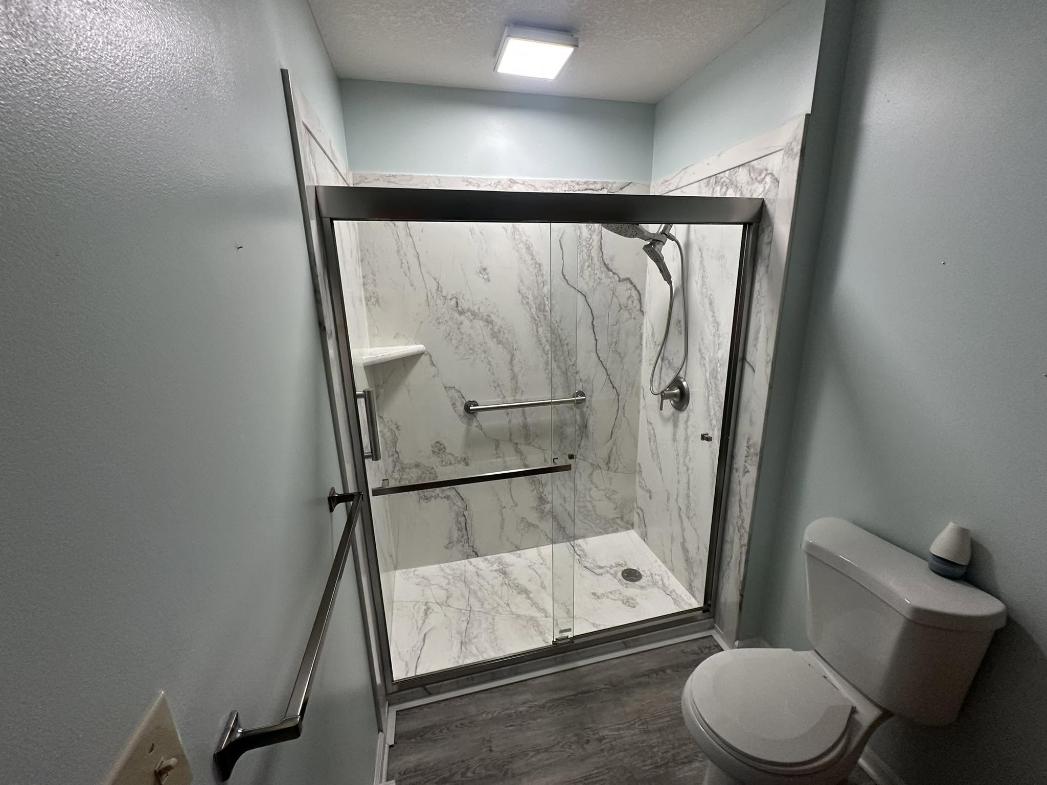Remodeled bathroom with marble-look shower surround