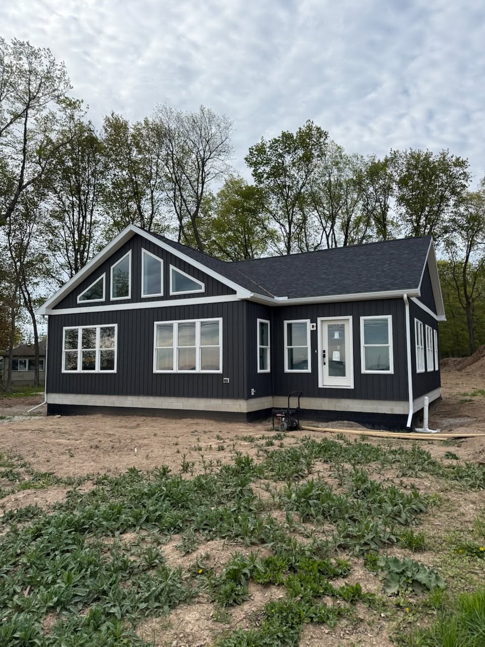 New construction home with dark navy siding built by Snoble Construction