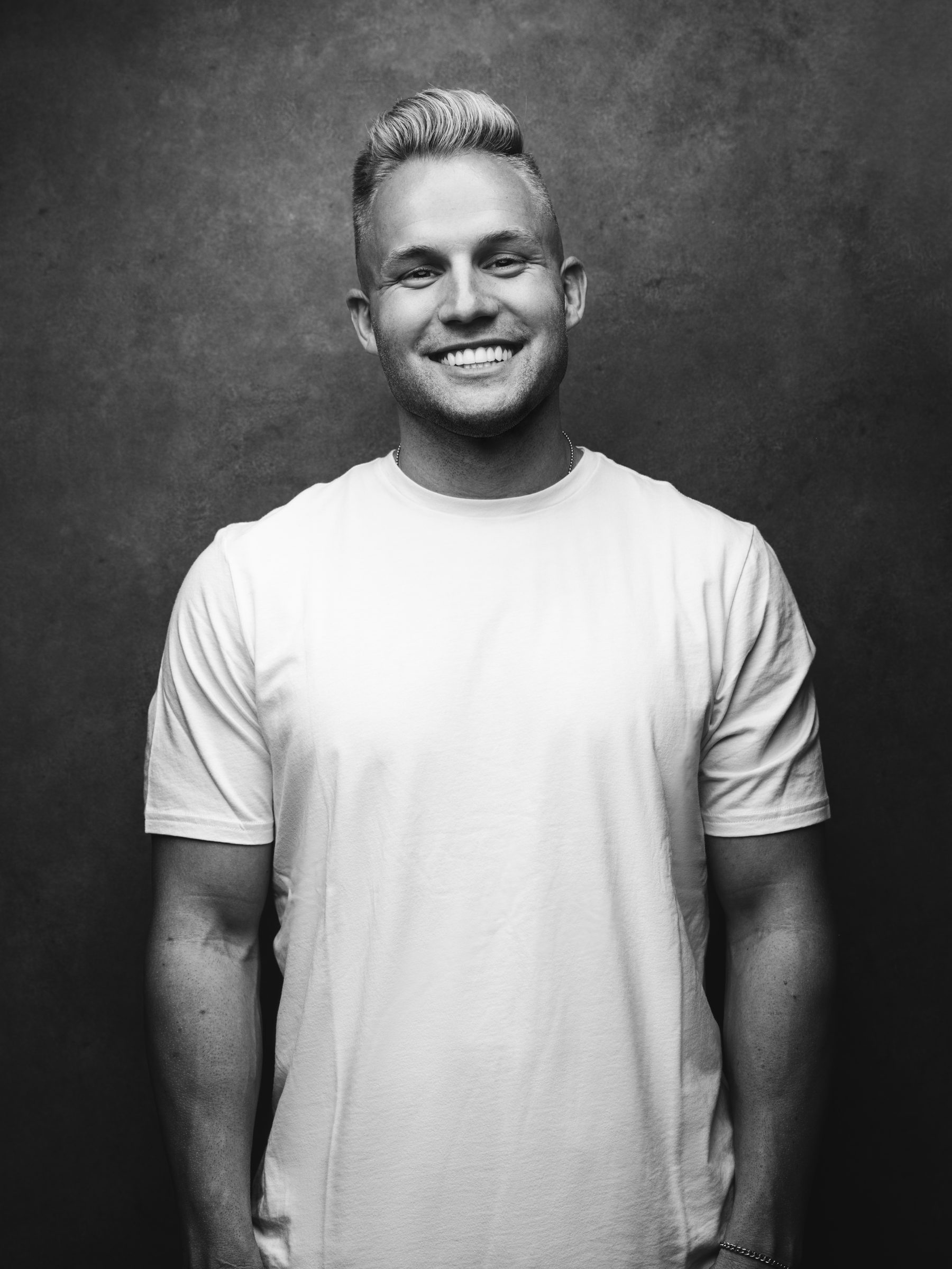 Black and white portrait of Blake Erickson in a white t-shirt