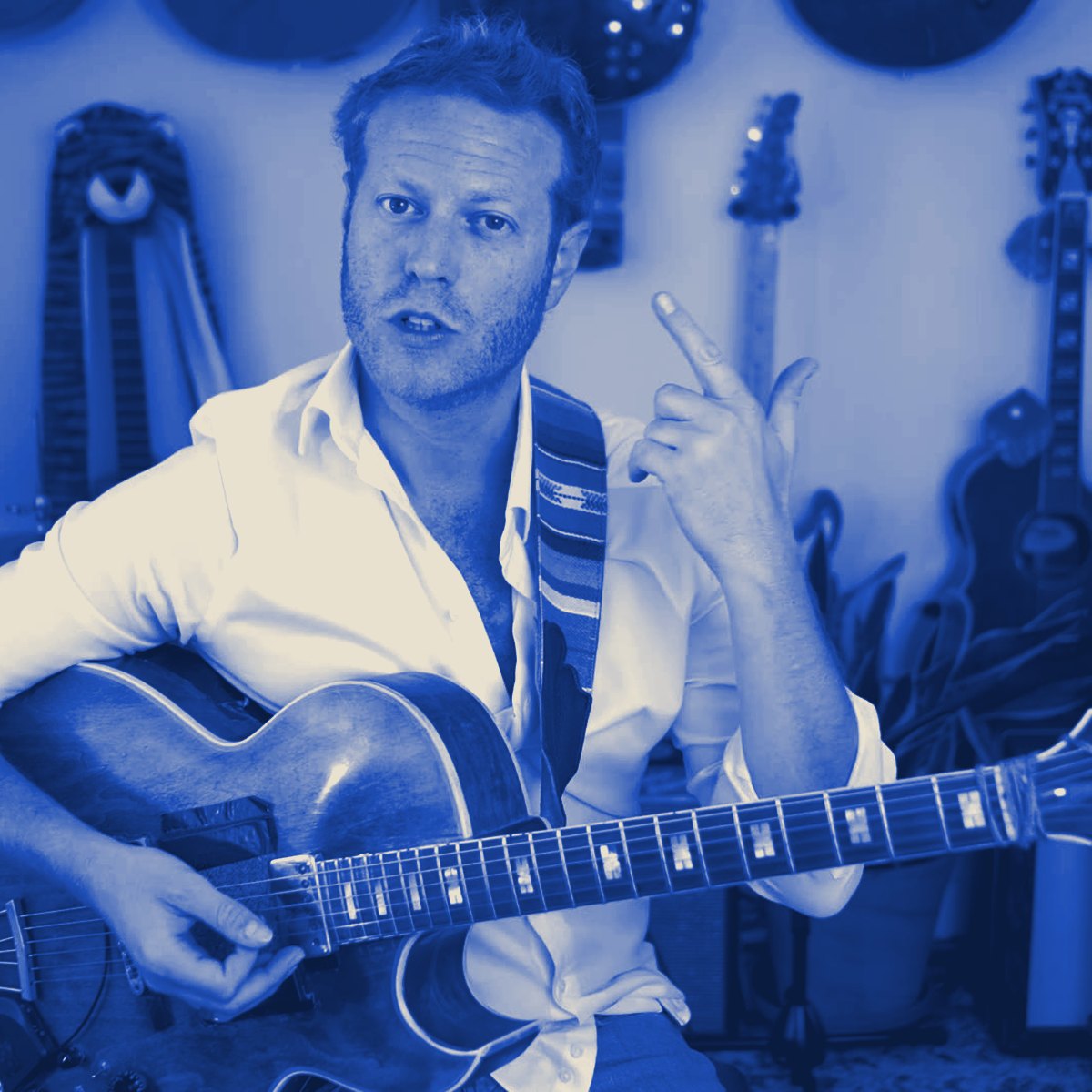 Rotem teaching with his guitar